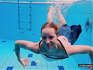 teenager lady Avenna is swimming in the pool